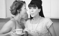 1960s style women gossiping in a kitchen - black and white photo