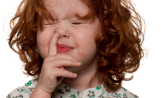 little girl picking her nose